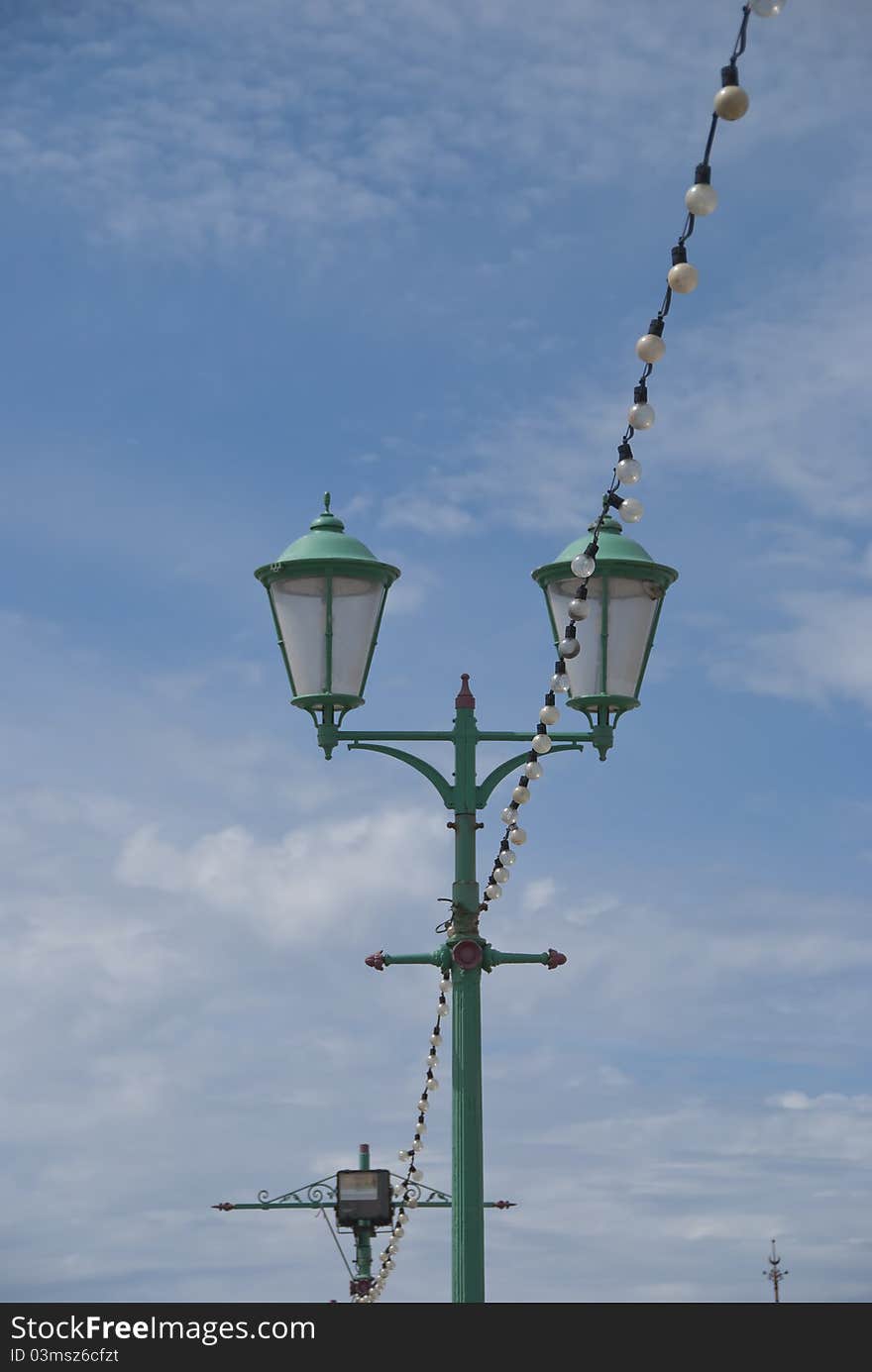 Vintage former Gas Lighting on a seaside pier under a summer sky. Vintage former Gas Lighting on a seaside pier under a summer sky