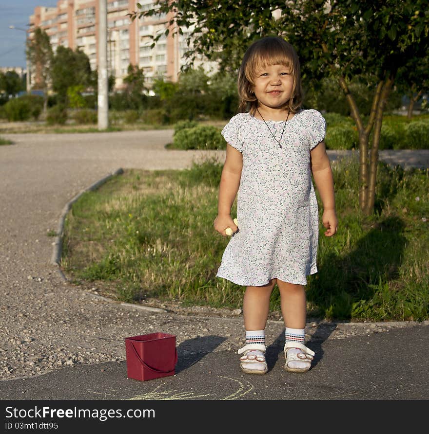 Portrait of blonde little girl outdoors in summer