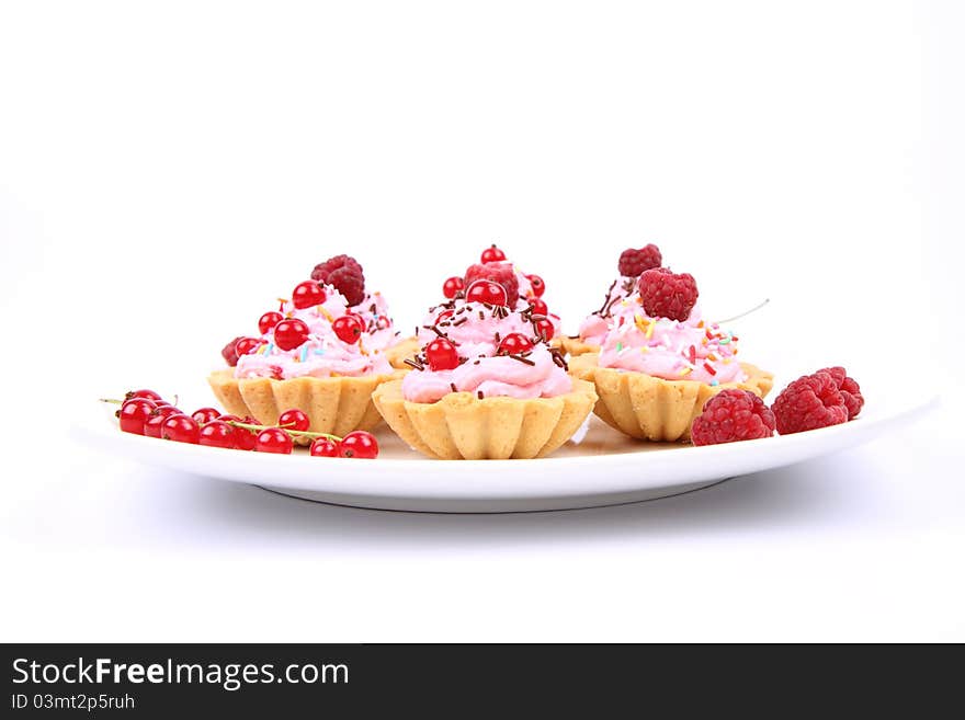 Tartlets with whipped cream, fruits and sprinkles