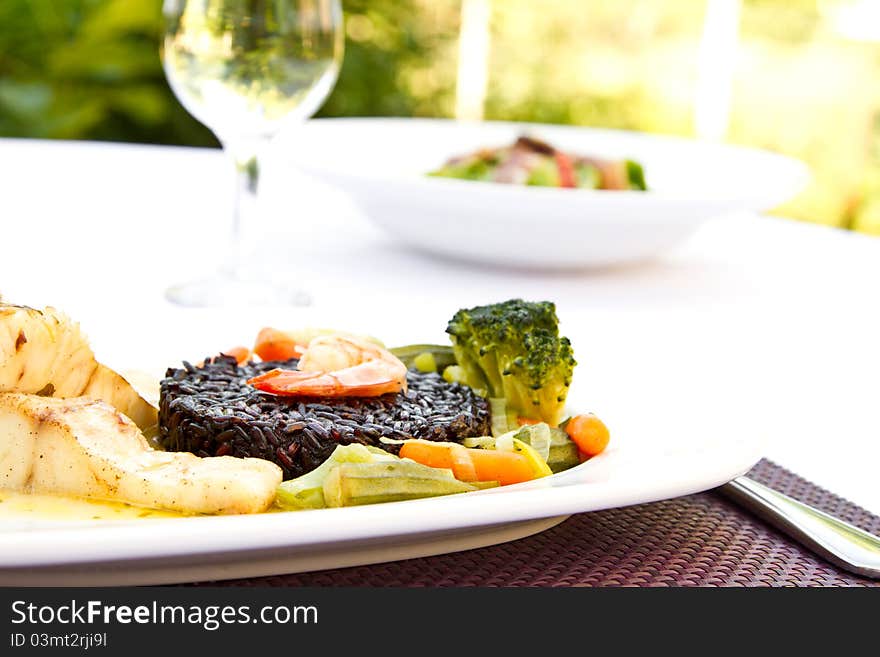 Fish with black rice, vegetables and prawn. Fish with black rice, vegetables and prawn