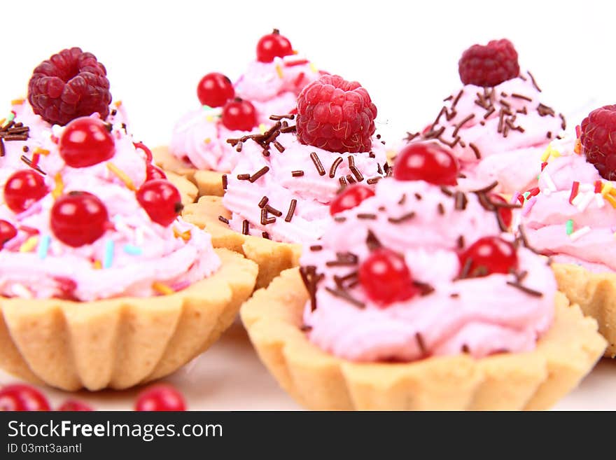 Tartlets with whipped cream, fruits and sprinkles