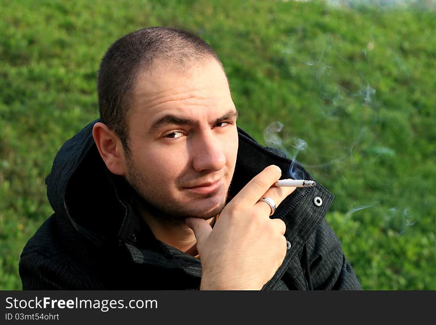 Caucasian man holding a cigar