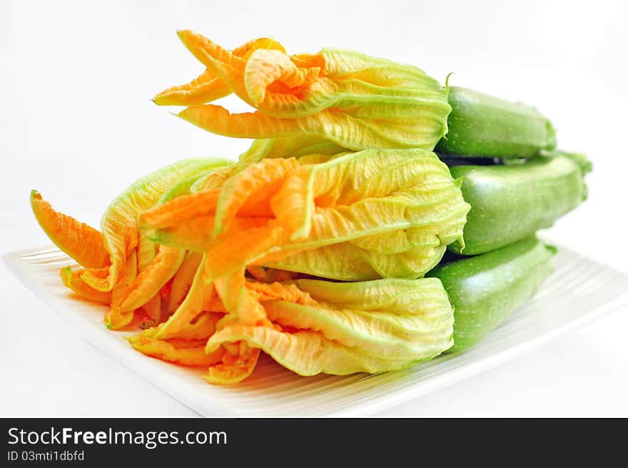 Zucchini with flowers on a white background