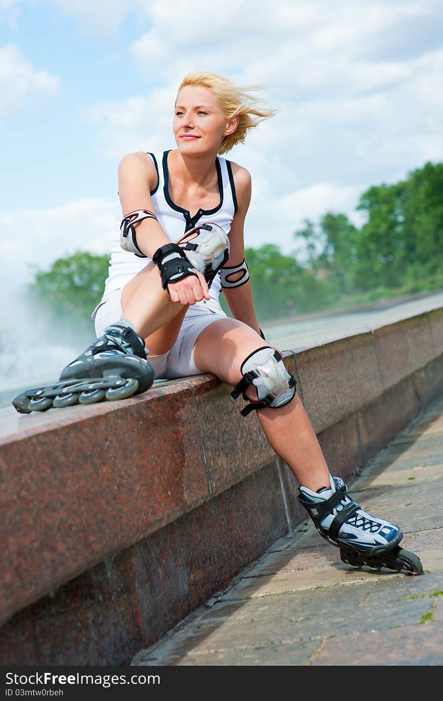 Roller blonde girl resting on the border