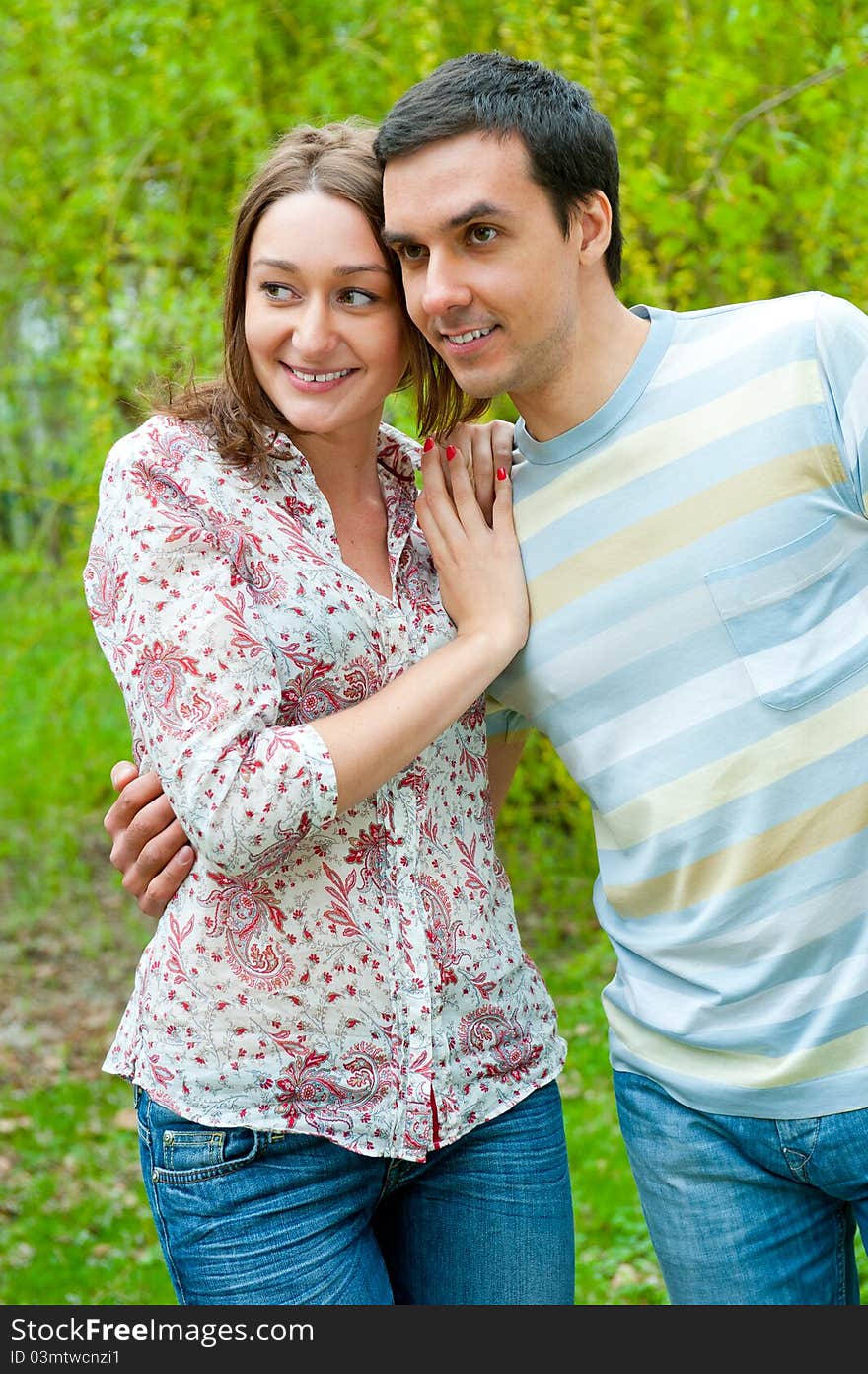 Beautiful young couple portrait in a park