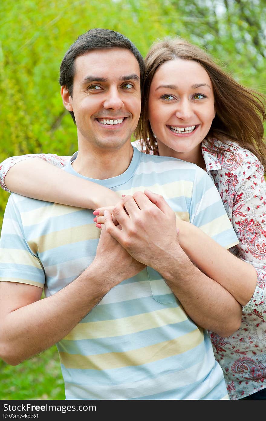 Beautiful young couple portrait in a park