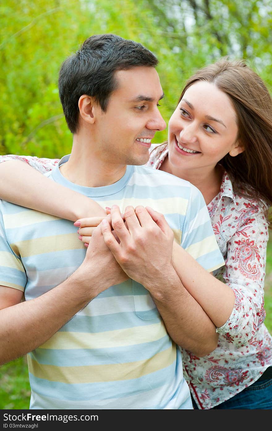 Beautiful young couple portrait in a park