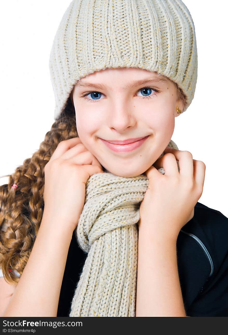 Beautiful little girl in cap and scarf  isolated on white