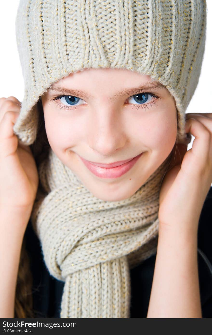 Beautiful little girl in cap and scarf isolated on white