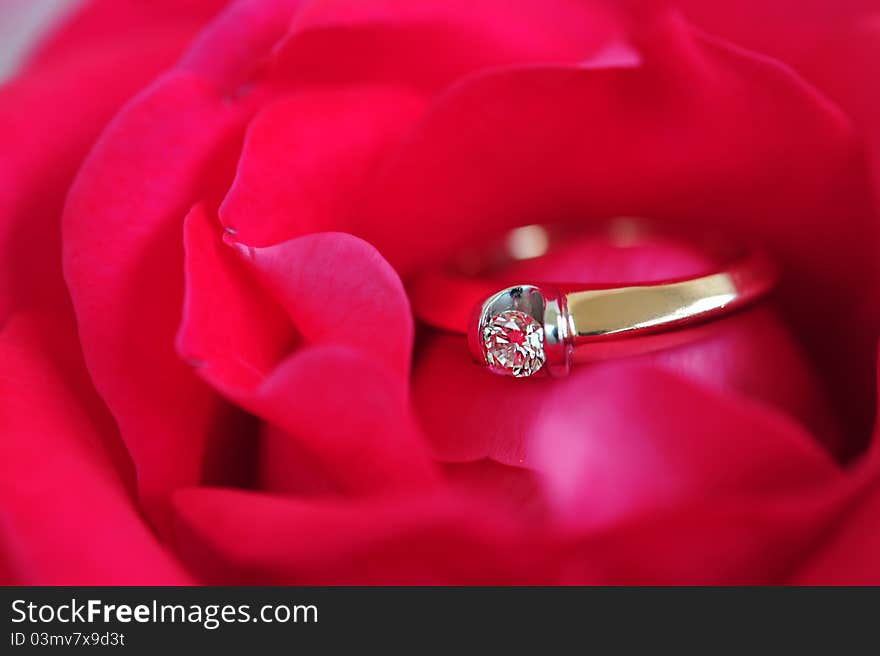 Gold ring with a diamond in the red rose