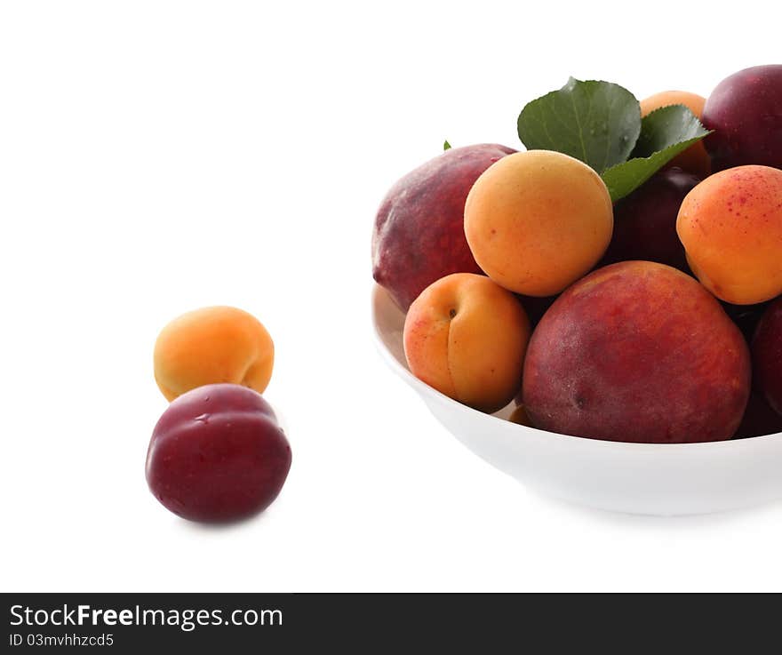 Fresh peaches, plums and apricots  in white bowl. Fresh peaches, plums and apricots  in white bowl