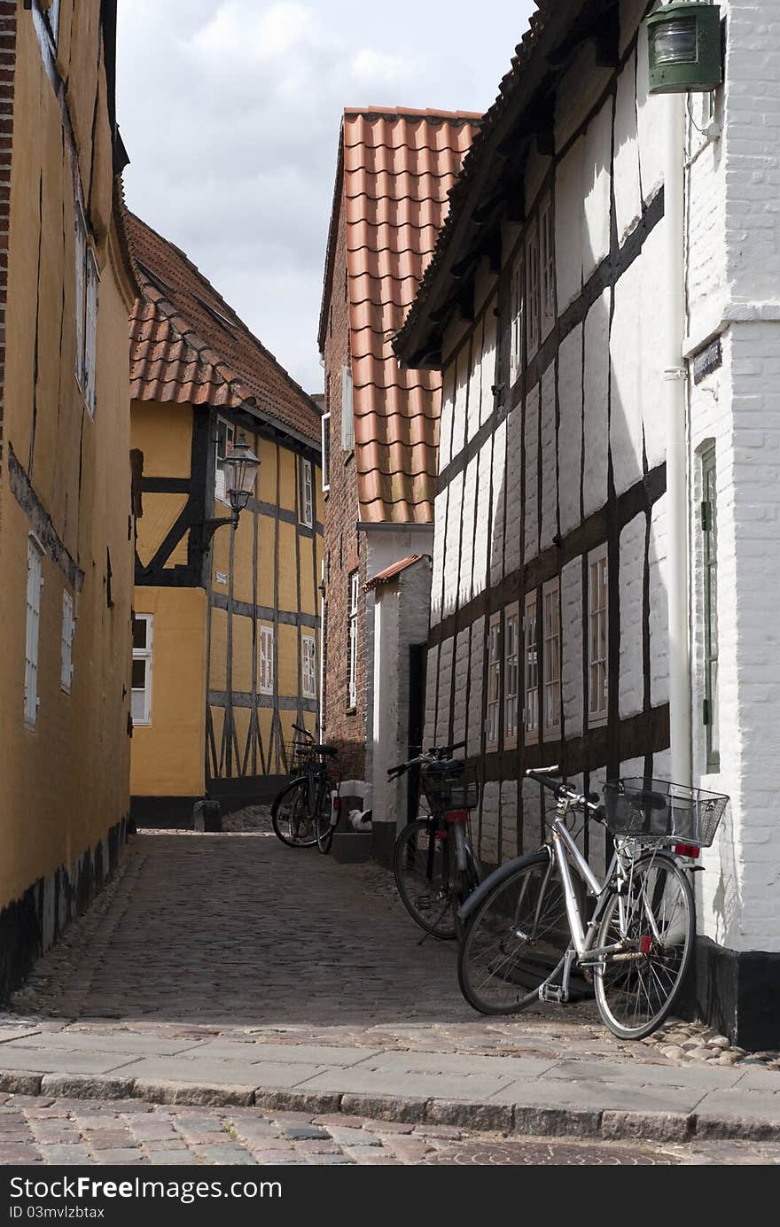 Narrow street with bicycles and buildings from Ribe in Denmark