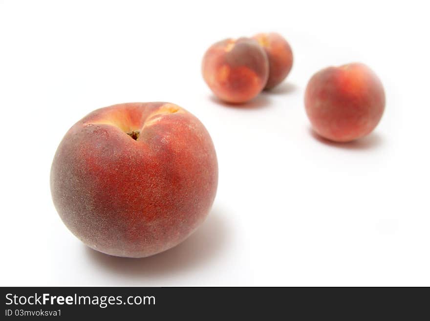 Ripe peaches on white background