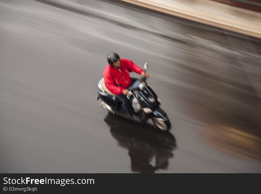 A moto scooter air panning with a long exposure time