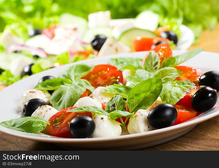 Salad with mozzarella and tomatoes. Salad with mozzarella and tomatoes