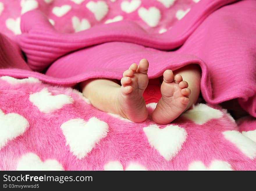 Newborn baby clutching mothers finger