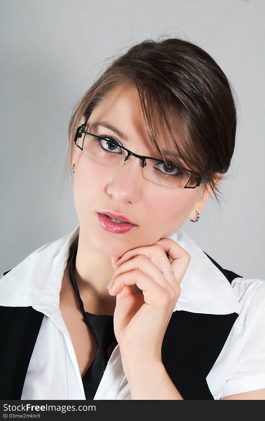 Young girl glasses touching her face. Young girl glasses touching her face