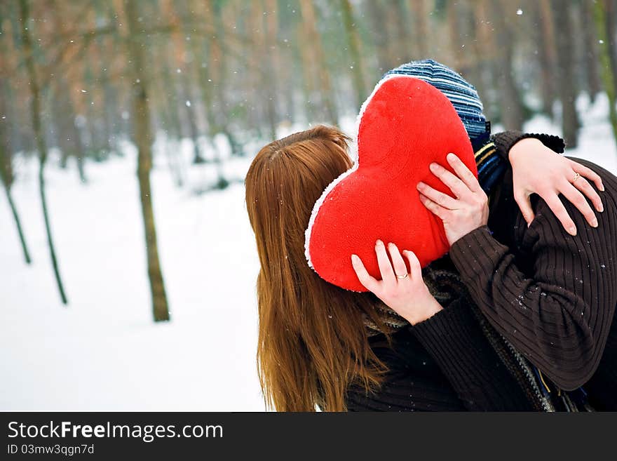 Couple with heart kissing, winter