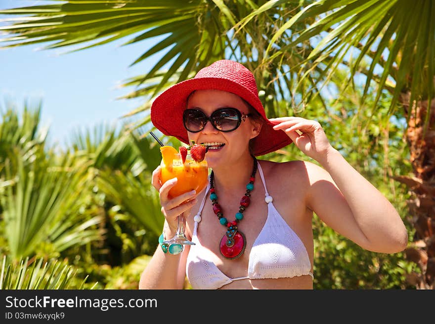 Young woman in bikini with cocktail