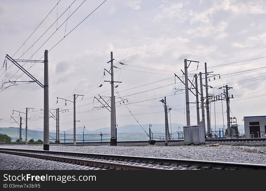 Railroad track, embankment, and power poles