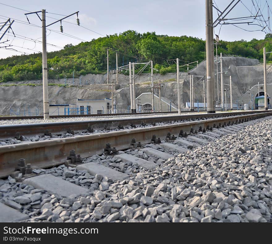 Railroad track, embankment, and power poles