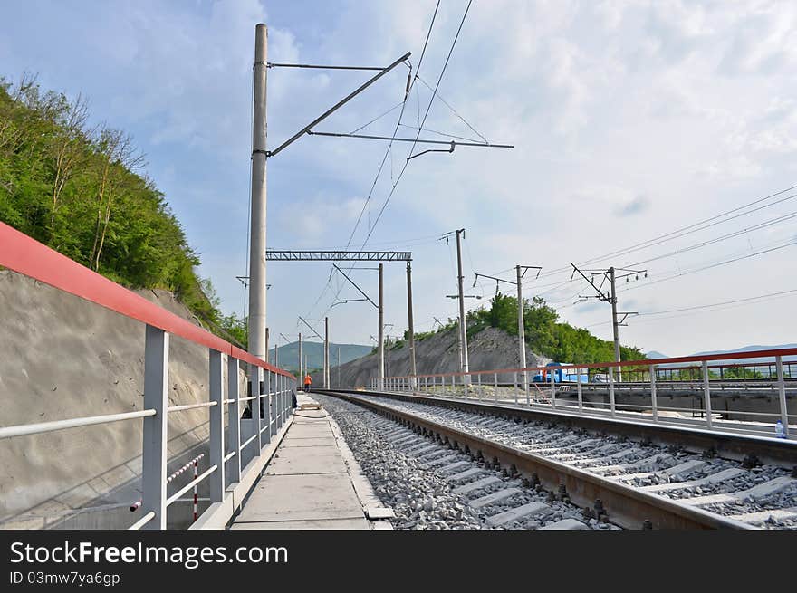 Railroad track, embankment, and power poles