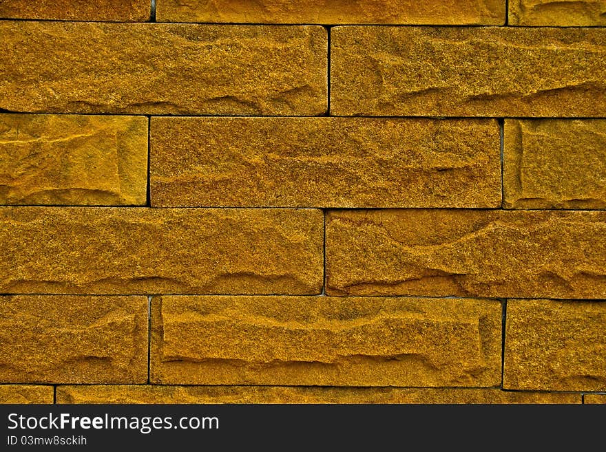 The yellow color brick wall texture