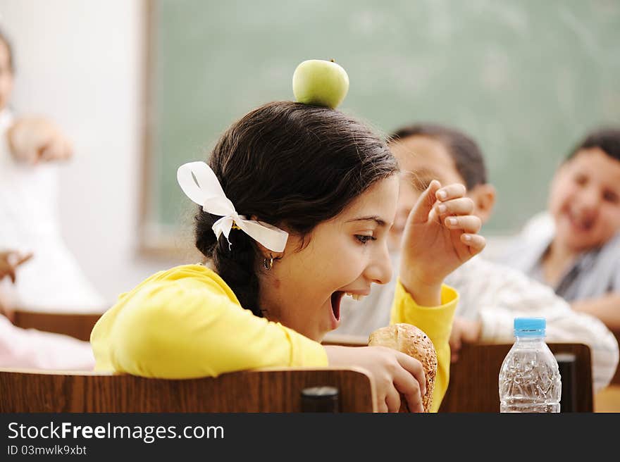 Children playing in classroom, happiness and togetherness with learning in education