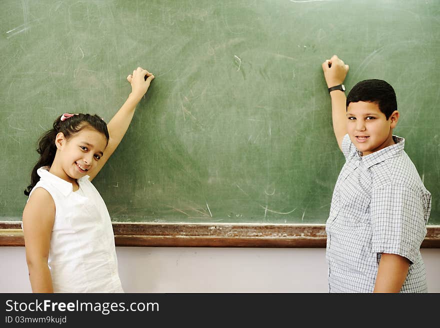 Boy and girl in front of school board. Boy and girl in front of school board