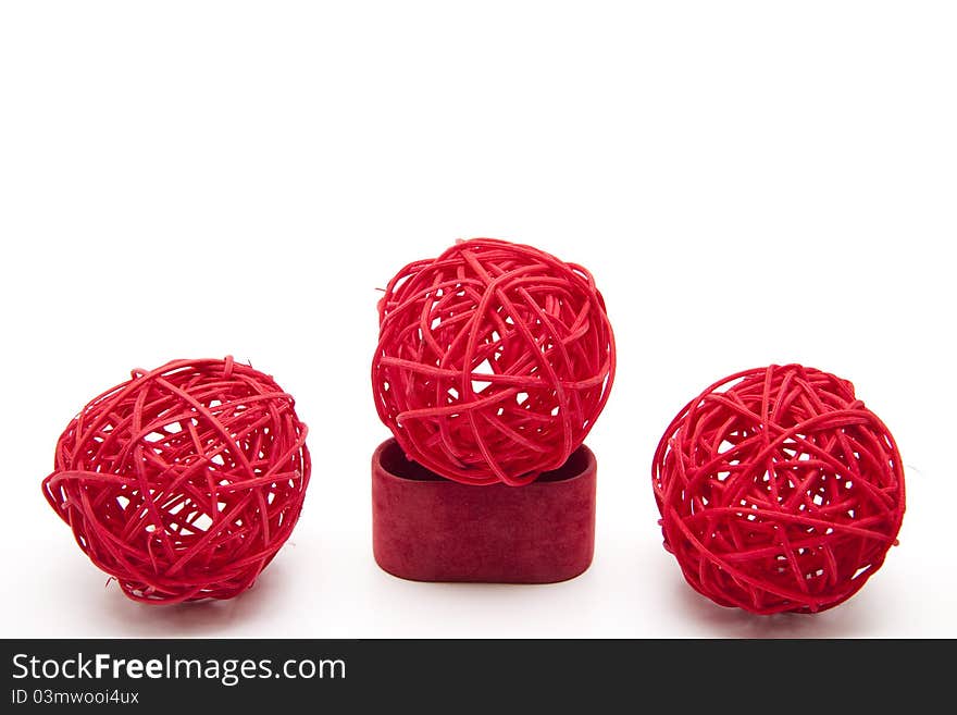 Red straw balls bound onto white background