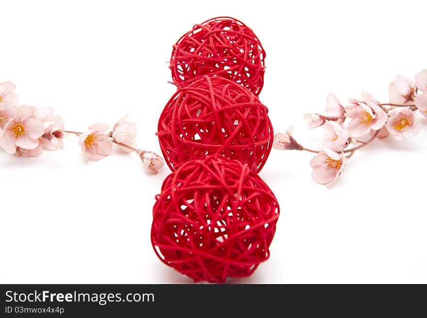 Red straw balls bound onto white background