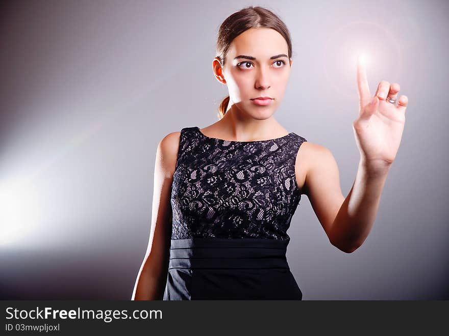 Attractive woman touching the energy ball in virtual future