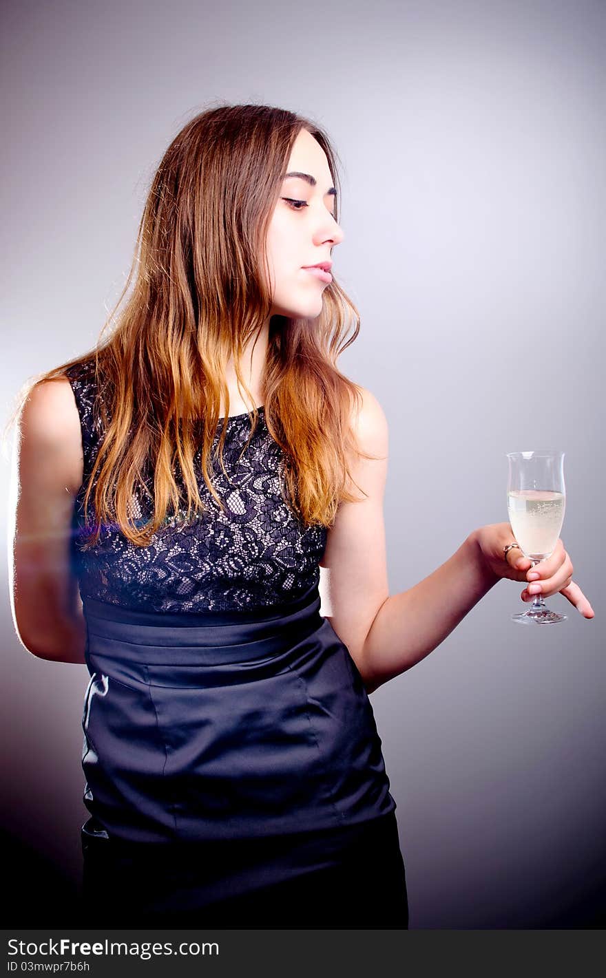 Young beautiful woman drinks wine from wine glass