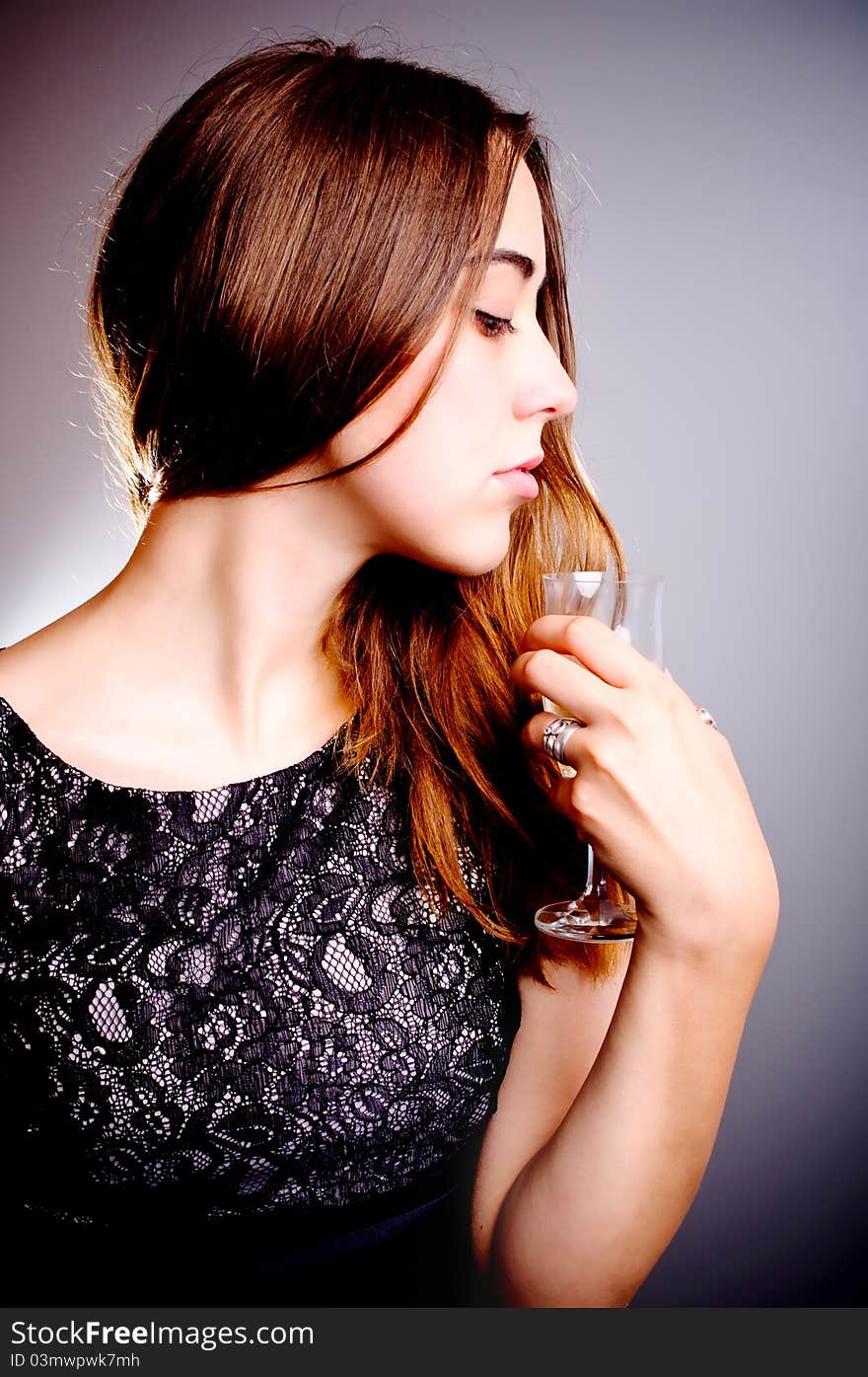 Young beautiful woman drinks wine from wine glass