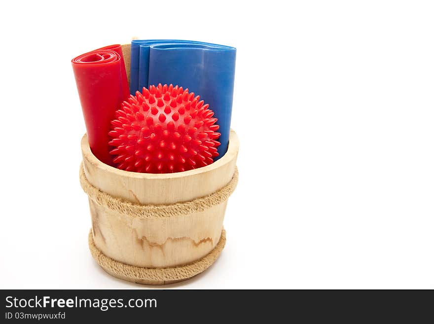 Massage ball and gymnastic ribbon in the wood receptacle