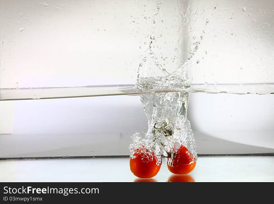 Tomatoes falling in water