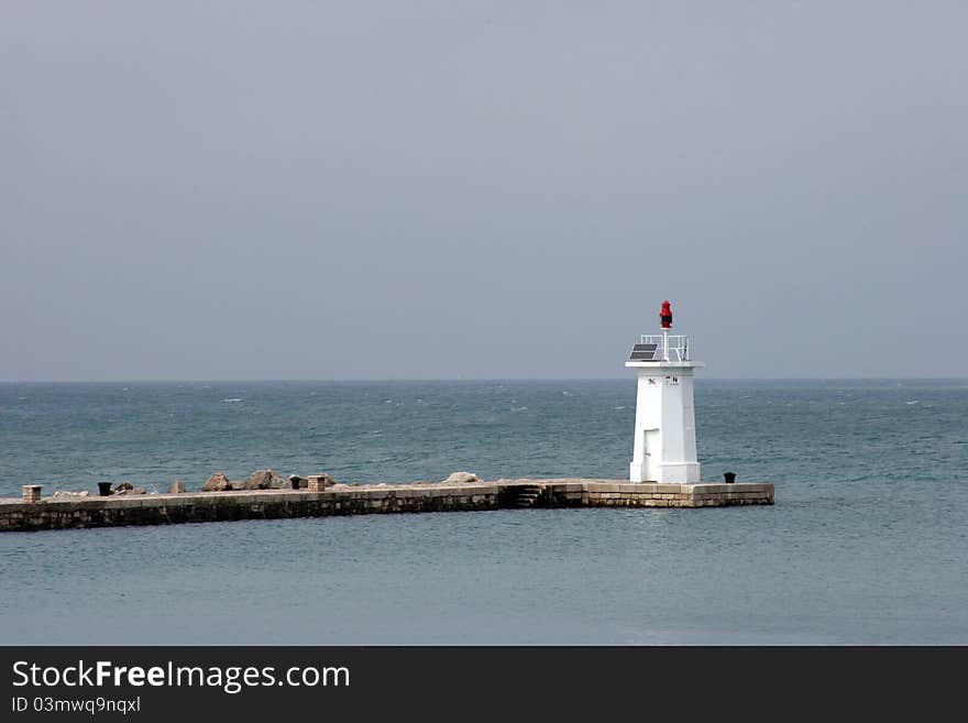 White light house in a port in Novigrad, Istria, Croatia. White light house in a port in Novigrad, Istria, Croatia