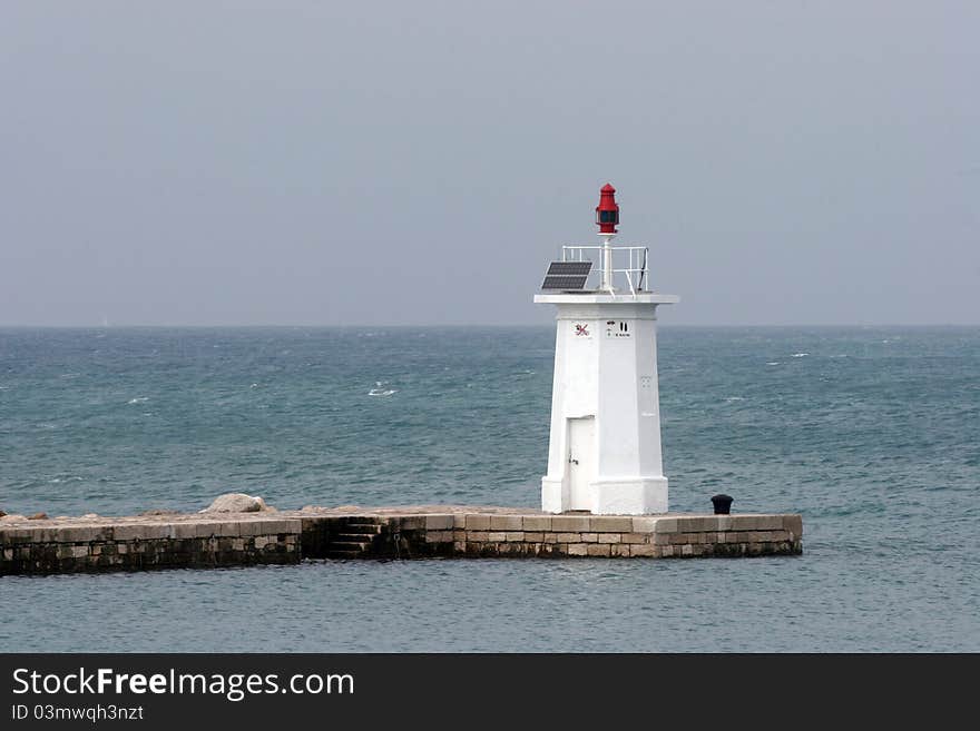 White light house in a port in Novigrad, Istria, Croatia. White light house in a port in Novigrad, Istria, Croatia