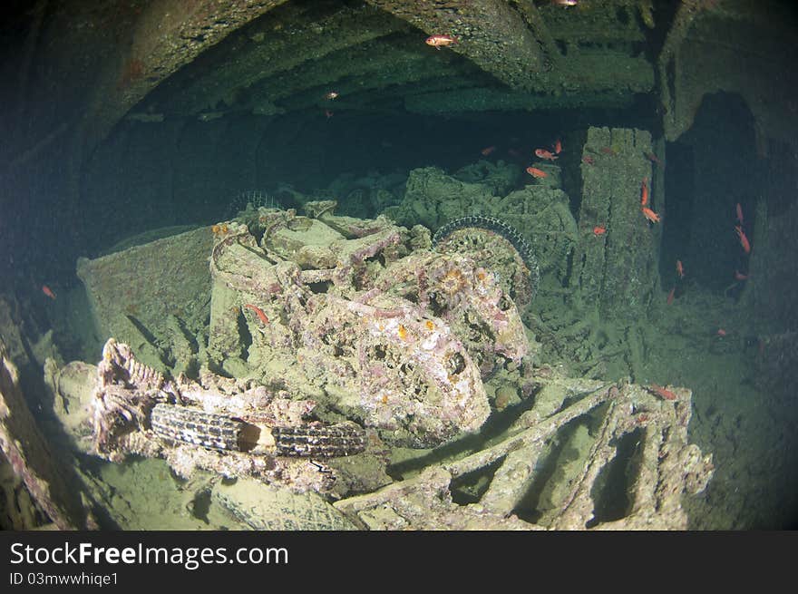 Old motorbikes inside the hold of a large shipwreck from world war 2. Old motorbikes inside the hold of a large shipwreck from world war 2