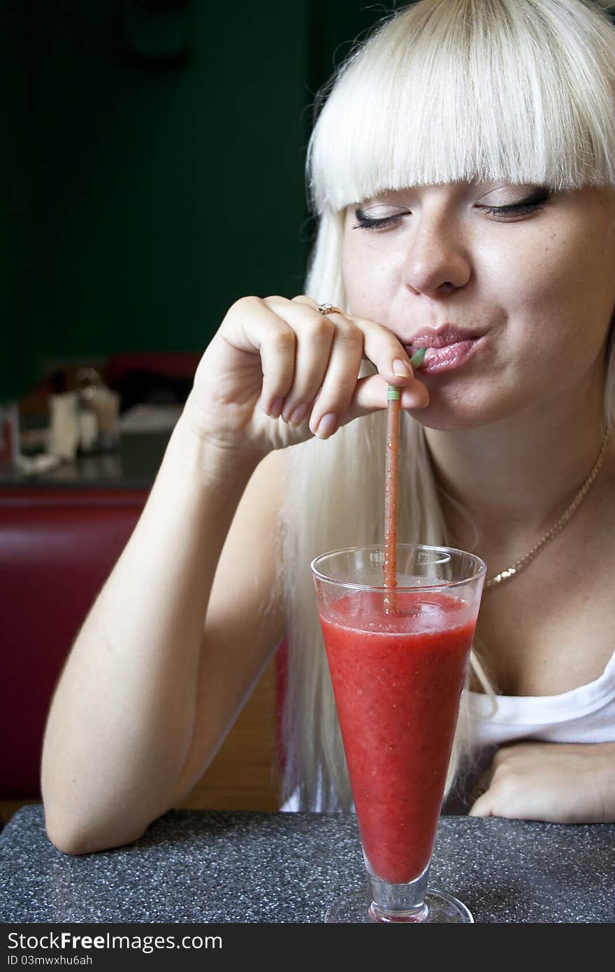 Young Woman Drinks Cocktail