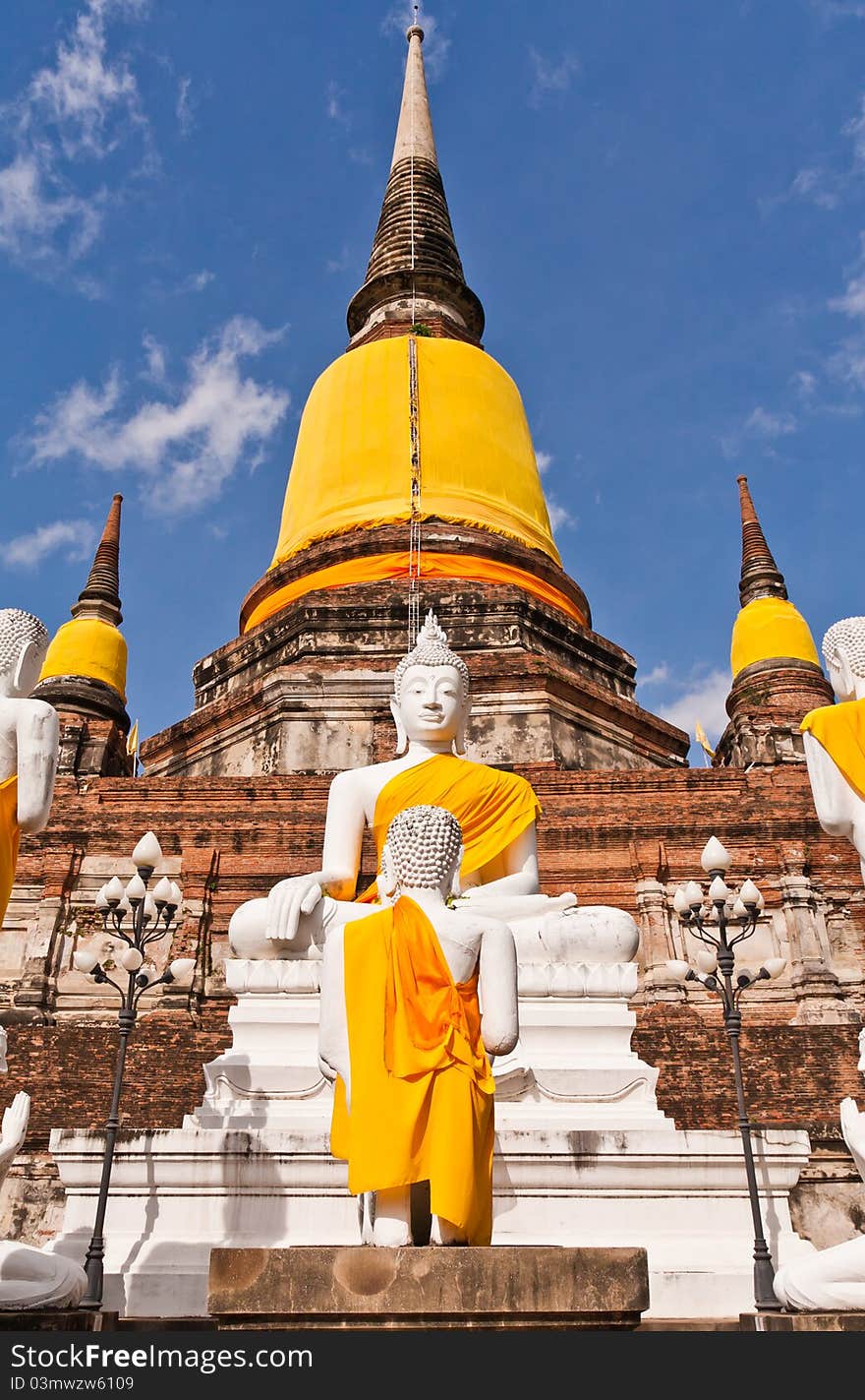 Buddha statues in front of ruin pagodas in Ayutthaya Thailand with blue sky. Buddha statues in front of ruin pagodas in Ayutthaya Thailand with blue sky