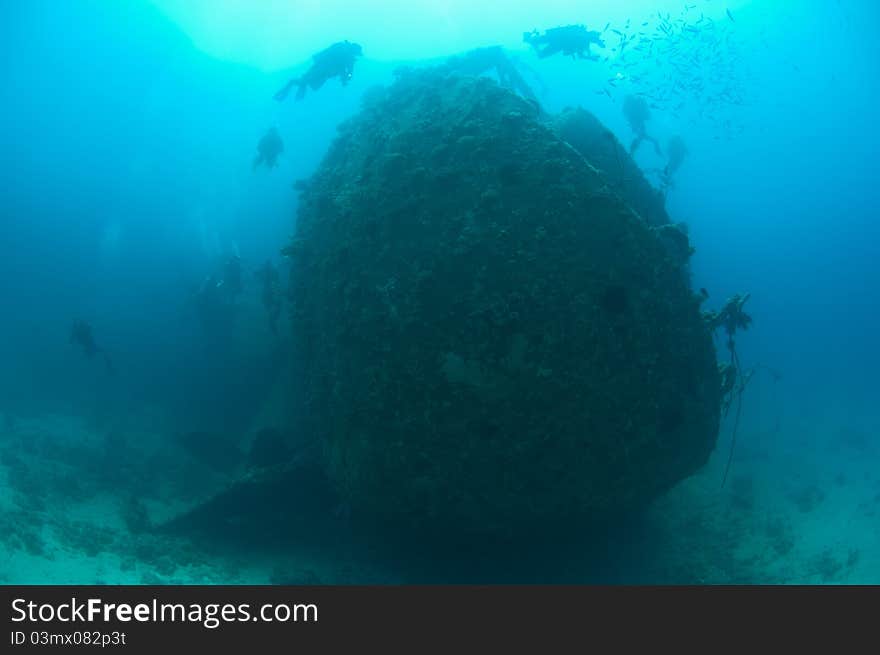 Divers exploring a large shipwreck