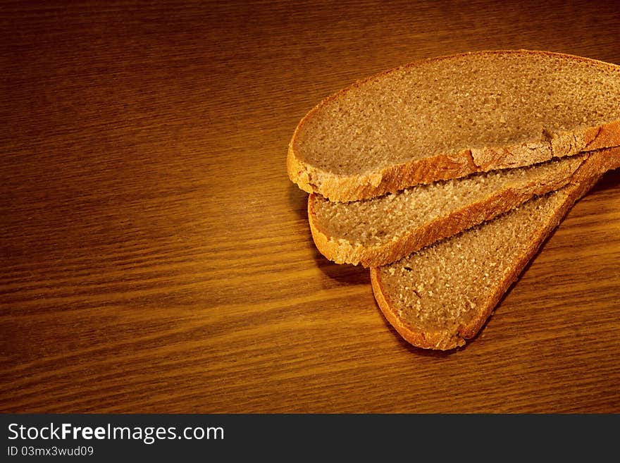 Sliced bread on wooden background