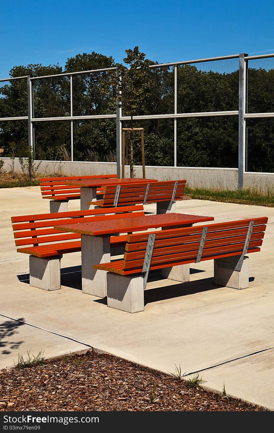 Resting place with benches and tables under blue sky. Resting place with benches and tables under blue sky.