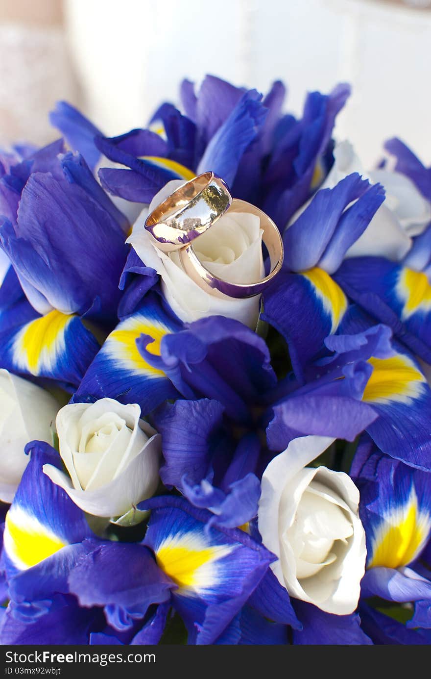 Wedding rings on wedding bouquet of irises