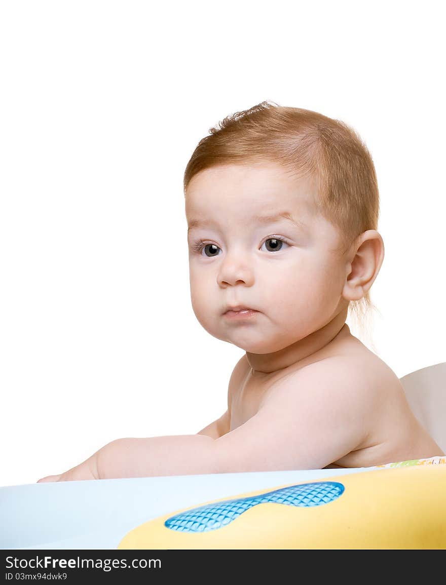 Child Sitting In Baby Chair.