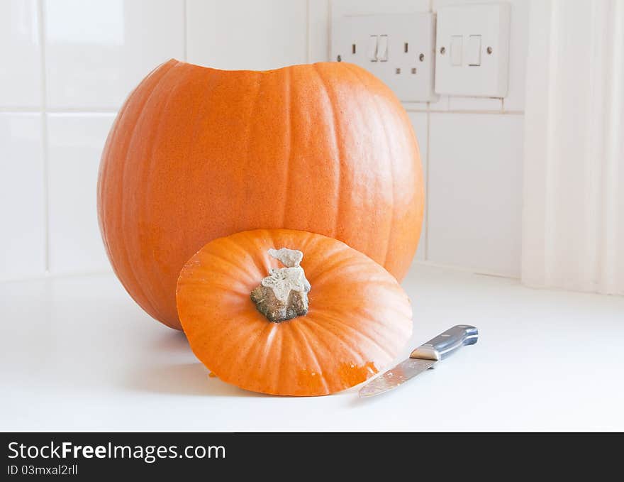 Preparing Halloween, a pumpkin and a knife in a kitchen. Preparing Halloween, a pumpkin and a knife in a kitchen