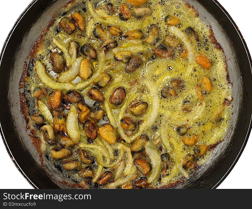 Mussels with onion being cooked in frying pan. Mussels with onion being cooked in frying pan.