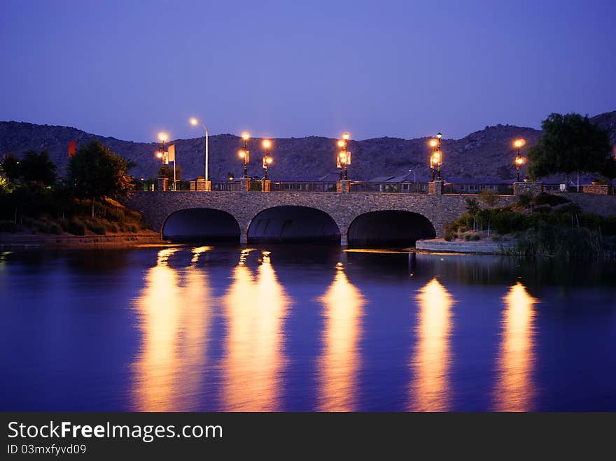 Bridge at sunset over lake.