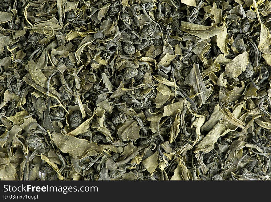 Dry green tea leaves background. Dry green tea leaves background